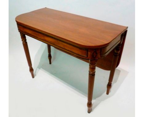 A 19th Century Mahogany Card Table, with a hinged flap raised upon turned reeded tapering legs