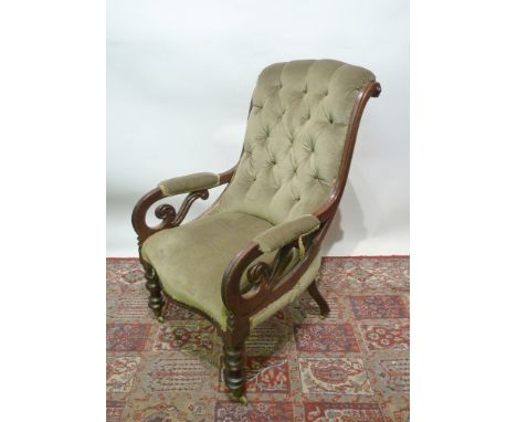 A Victorian Mahogany Drawing Room Armchair, with a button upholstered back above scroll arms raised upon turned legs with bra