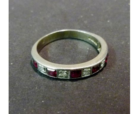 An 18ct. White Gold Ruby and Diamond Band Ring