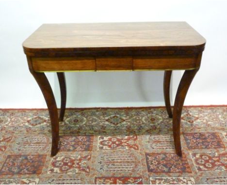 A Regency Rosewood Brass Inlaid Card Table, the hinged top enclosing a baize lined interior above a plain frieze, raised upon