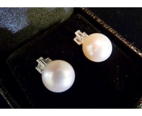 A Pair of White Gold Diamond and Pearl Ear Studs, each set with baguette diamonds and with single pearls