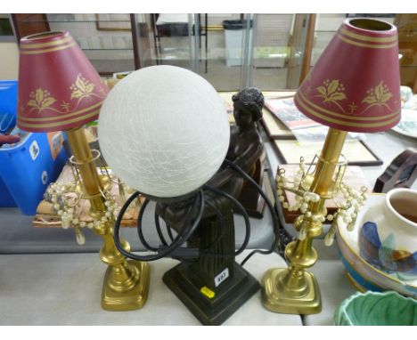 Bronzed effect table lamp in the form of an Art Deco figurine holding a globular shade and a pair of Victorian brass candlest