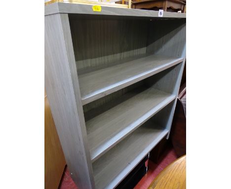 Modern lime washed style adjustable bookcase and a glass and chrome TV stand