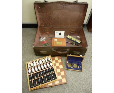 Vintage suitcase and contents including a modern chess set, set of balance scales etc