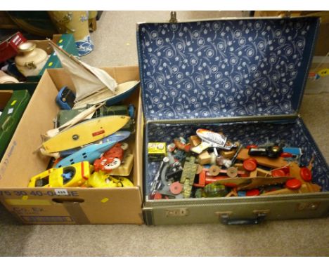 Box of vintage pond yachts, toy submarines and vehicles along with a vintage suitcase of toy pistols, space guns, wooden pull