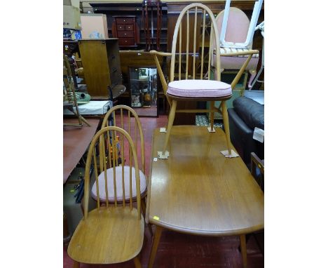 Ercol mid oak twin flap dining table and seven (four plus three) spindleback light wood dining chairs