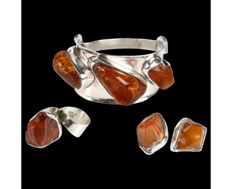 A Danish sterling silver and Baltic amber jewellery set, comprising torque bangle, ring and pair of clip-on earrings, bangle 