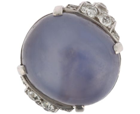 An exceptional Art Deco lavender star sapphire and diamond ring, circa 1930, centrally claw set with 32ct oval cabochon star 