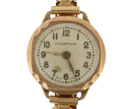 PRESTIGE - a lady's 9ct gold mechanical wristwatch, silvered dial with applied gilt Arabic numerals, spade hands and rolled g