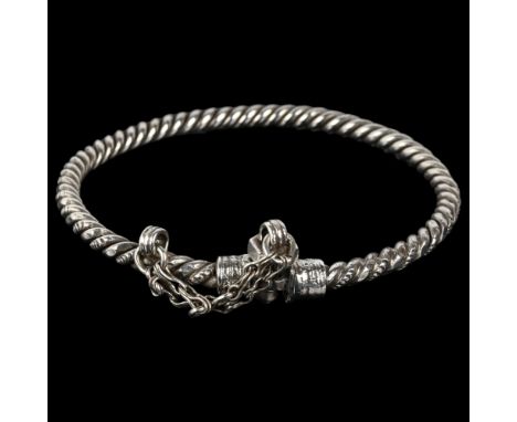 A large Eastern white metal torque bangle, rope twist form with bolt clasp, apparently unmarked, band width 5.8mm, internal c