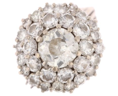 A large mid-20th century diamond cluster ring, claw set with old and modern round brilliant-cut diamonds, principal diamond a