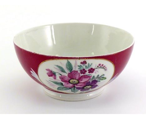 A Russian ceramic bowl by Gardner, decorated in the traditional manner with white panels of anemones on the deep red body. Ba