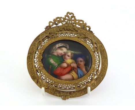 A 19th. century Continental miniature ceramic oval  plaque of a classical group of a mother and two children, set in an ornat