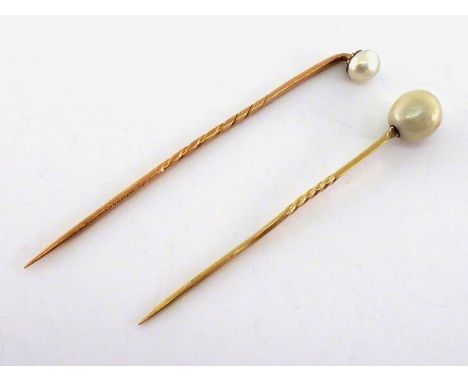 Two 19th century pearl-set stick pins, both pearls untested, the larger 9.2 x 7.8mm, mounted on gold (tests 14 carat) pins, 2