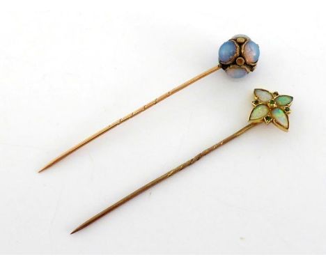 Two Victorian gold and gem set stick pins, the first set about the spherical head with rub over set circular moonstone caboch