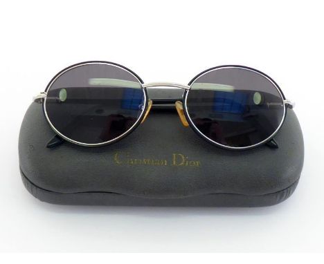 Christian Dior, a pair of sunglasses, in their case 