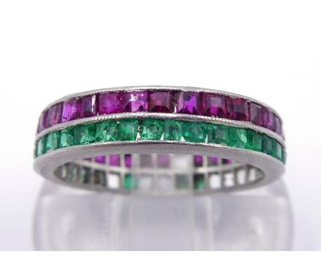 An emerald and ruby eternity ring, channel set with a row of calibre cut rubies, a row of emeralds below, mounted in platinum