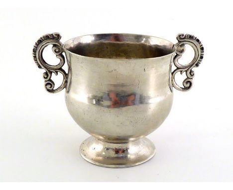 A South American silver two-handled cup, unmarked, possibly late 18th/early 19th century, with rococo "S" scroll handles and 