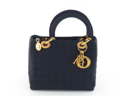 A Christian Dior Cannage quilted handbag with goldtone Dior logo charm. Labelled Christian Dior Paris, Made in Italy. Comes w