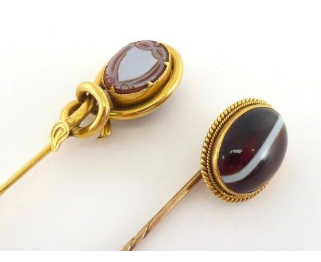 A Victorian 18 carat gold and banded sardonyx stick pin, the oval cabochon stone in a wirework border, the head 18mm long, 3.