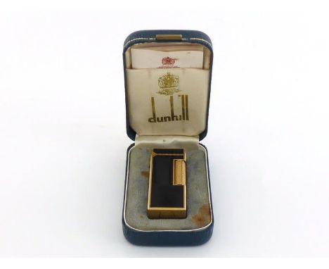 A Dunhill gas cigarette lighter with black lacquer finish in original presentation case.  In very good condition, some staini
