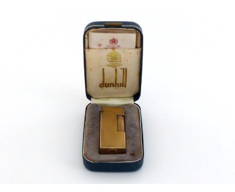 A gold plated Dunhill gas cigarette lighter with engine turned finish in original presentation case. In good condition  but a