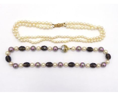 A two strand cultured pearl choker, composed of graduated 6.6 to 4.8mm, to a 9 carat gold bow clasp, 38cm long, together with