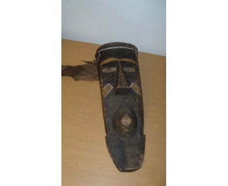 A Bashongo wooden mask, 55cm (21.5 in) high, an Asmat wooden bowl or ladle, 36cm (14 in) wide, together with six stools 