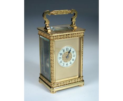 A French gilt brass carriage clock with floral banded decoration, the typical shape case Arabic chapter ring, floral bands in