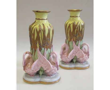A pair of Worcester vases, dated 1863, the yellow bodies gilt and moulded with bulrushes above groups of three pink swans wit