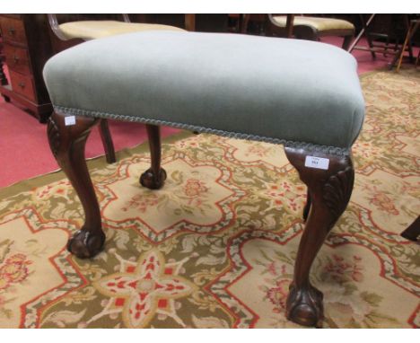 An early 20th century blue upholstered stool on cabriole legs and claw on ball feet 