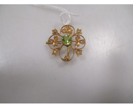 A peridot and seed pearl pendant together with a bracelet stamped 'Tiffany' and later charms 