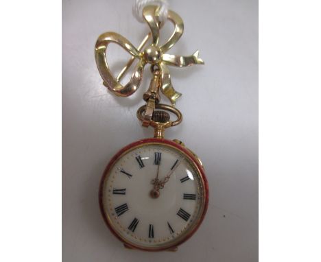 A lady's 14ct fob watch, with enamelled case, gilt decorated cream dial and baton numerals, with an associated bow brooch sta