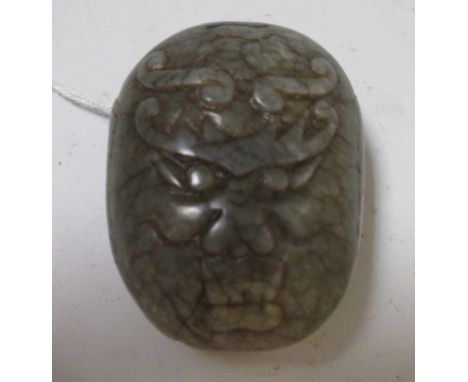 A Chinese spinach green jade belt buckle carved with a dragon's head 
