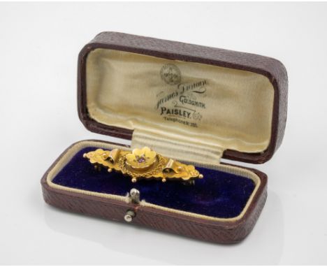 A cased Edwardian 9ct gold, ruby and diamond bar brooch, Chester 1910, the lozenge shaped brooch with central flowers, set wi