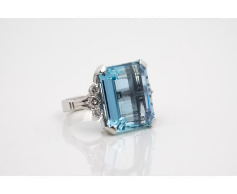 An 18ct white gold, aquamarine and diamond ring, hallmarked NP (N. St. J. Paint & Sons Jewellers, Guernsey), the large emeral