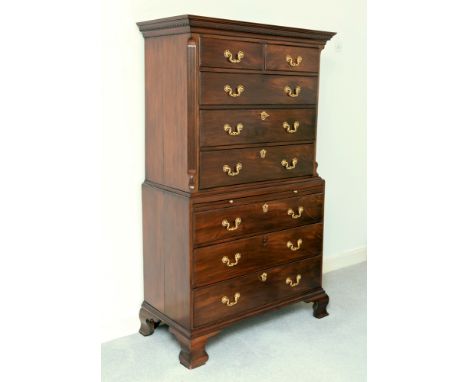 An early George III mahogany tallboy, with dentilled moulded cornice above two short and three long drawers with regilded pie
