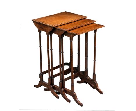 A nested set of three Regency style rosewood tables, late 19th century, each fruitwood strung top with looped angles, on ring