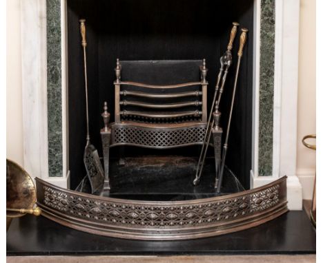 A George III pierced steel bowfronted fender, with linked paterae and discs within stud and pierced bead borders, 41½in. (105