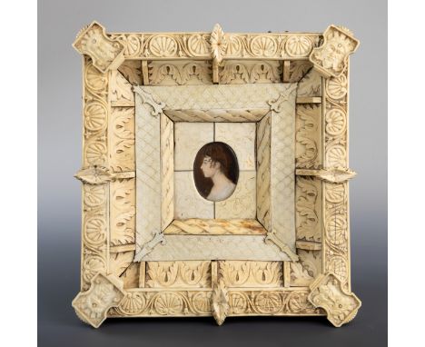 A North European carved ivory frame, c.1820, decorated with anthemions and acanthus leaves, mask plaques to the angles and fo