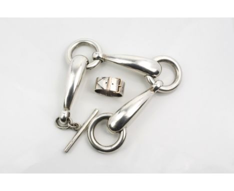 A silver and rose gold scarf ring, S. J. Rose & Son, London 1965,in the form of a belt with rose gold buckle; together with a