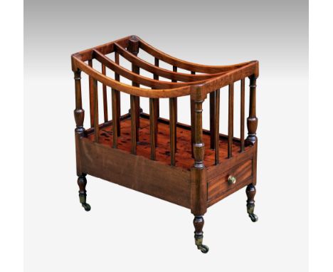 An early 19th century mahogany Canterbury, the dipped top with three divisions and reeded slates, the angles with vase shaped
