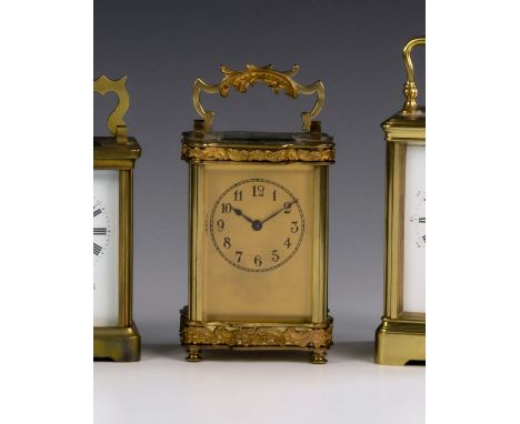 A French gilt brass Louis XV Doucine cased carriage clock timepiece, c.1900, the gilded face with painted Arabic dial, the se