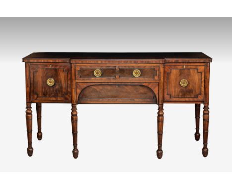 A late Regency mahogany breakfront sideboard, with ebony strung mouldings, the centre with a banded shallow drawer above anot