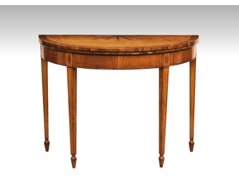 A George III satinwood demi-lune card table, the top inlaid with a fruitwood fan-shaped medallion and pendant husks, the band