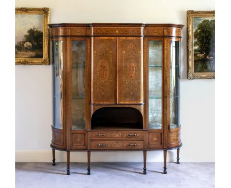 A fine late Victorian marquetry break bowfront display cabinet, c.1900, in the manner of Edwards & Roberts, the flared, ogee 