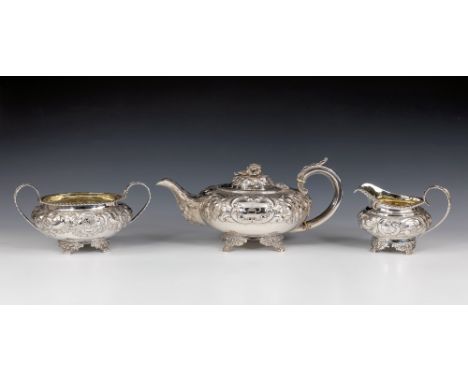 A matched George IV silver three piece tea service, London 1823-29, of compressed spherical form, each elaborately chased wit