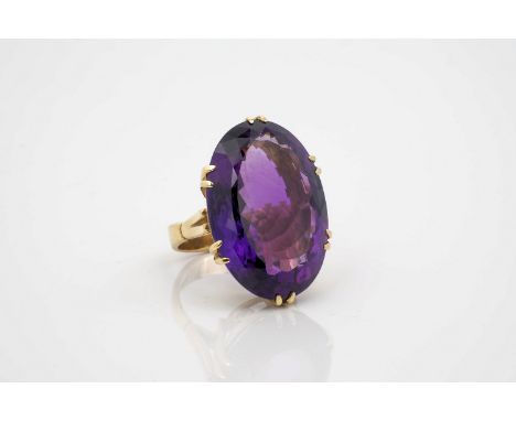 A vintage 9ct gold and amethyst dress ring, hallmarked NP (N. St. J. Paint & Sons Jewellers, Guernsey), the large oval cut am