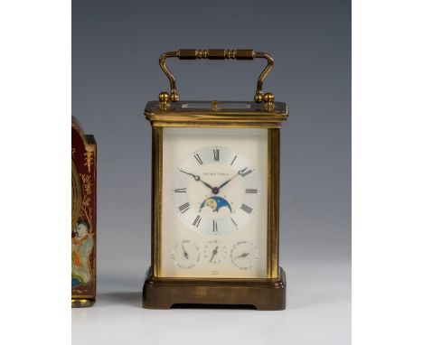 A brass repeating carriage clock by Matthew Norman of Switzerland with complications, in Corniche case, the signed white enam