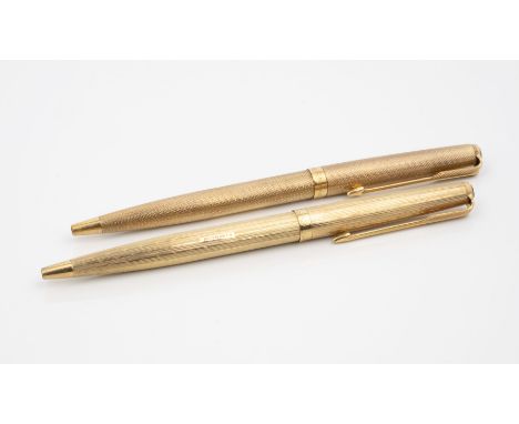 Two 9ct gold cased Parker 61 Presidential ballpoint pens, both hallmarked London 1975, with engine turned decoration. (2)